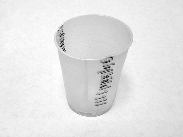 Plastic Cup repaired with staples 2005